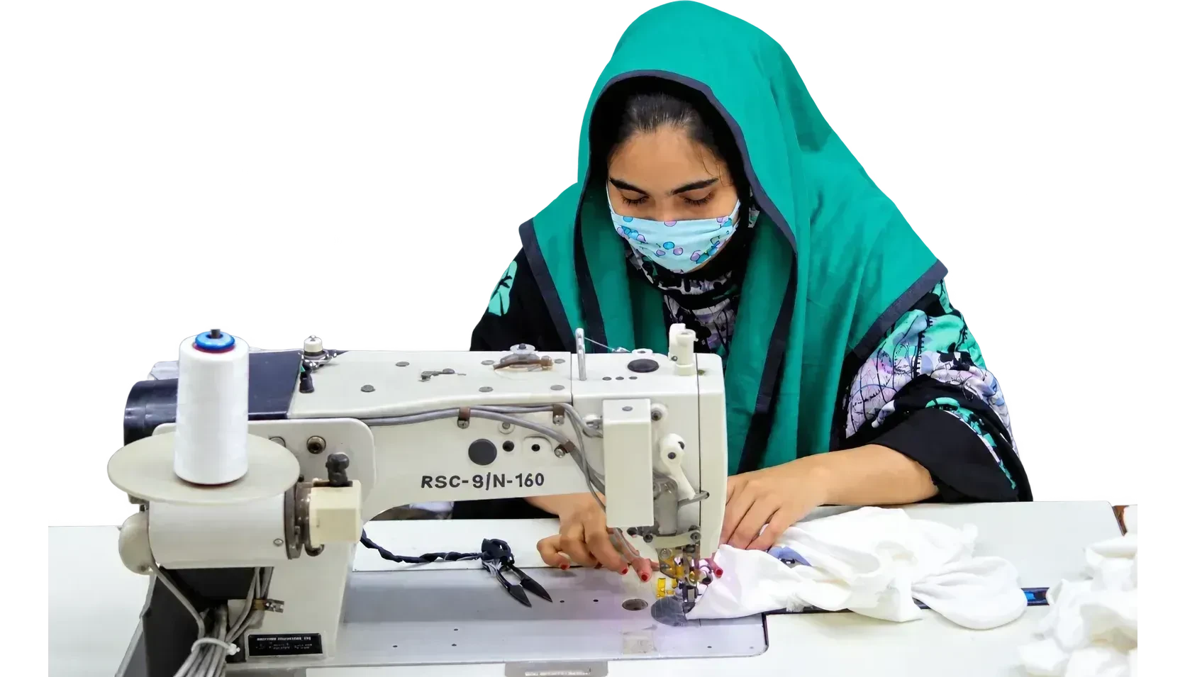 A sewing operator at an industrial machine on the sewing floor