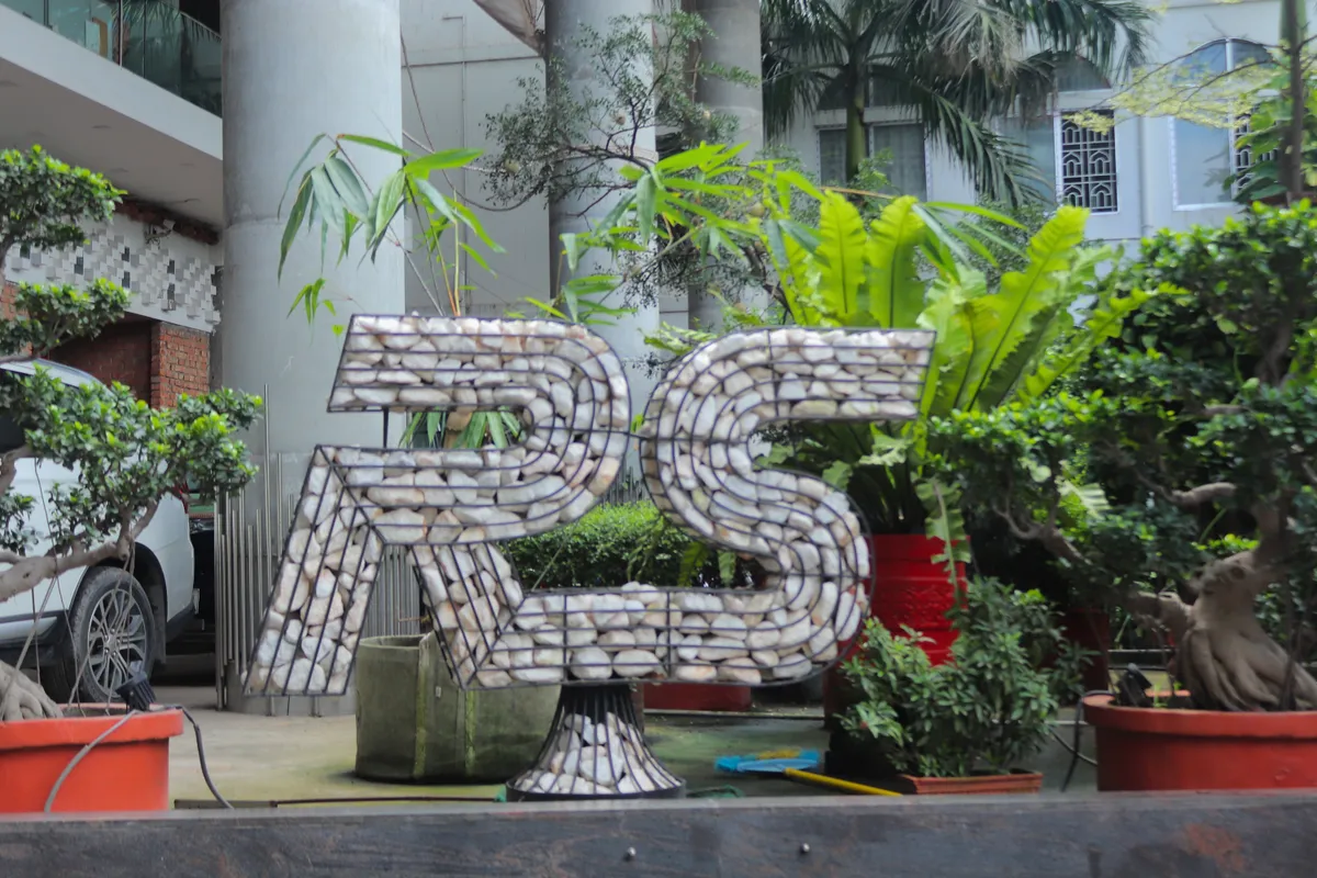 An RS monogram planted with greenery beside the site entrance