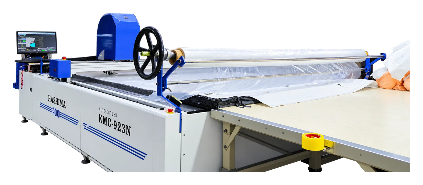 A Hashima automated cutting machine spreading white fabric across its table